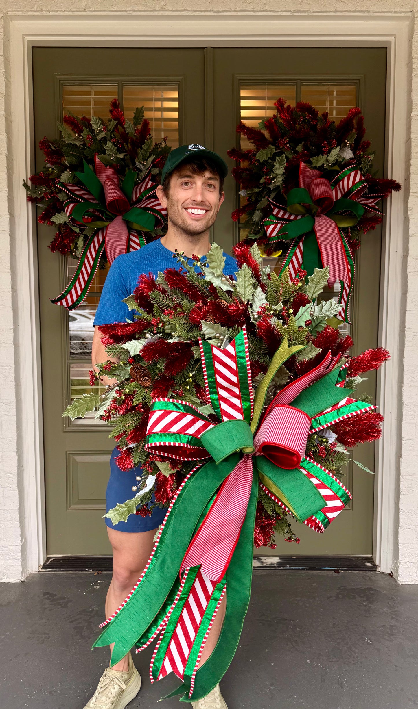 Red tinsel wreath with JME hand-tied bow. About 24 inches wide.