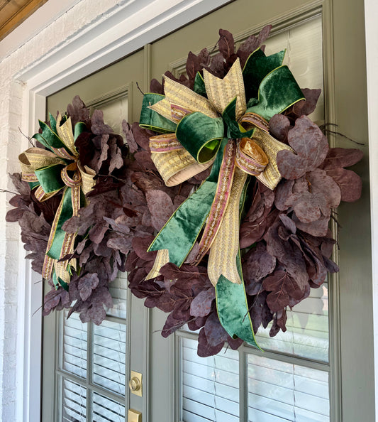 Faux plum colored fig leaf wreath with a JME hand tied bow. Green velvet, golds, and maroons with sparkle. About 32inches