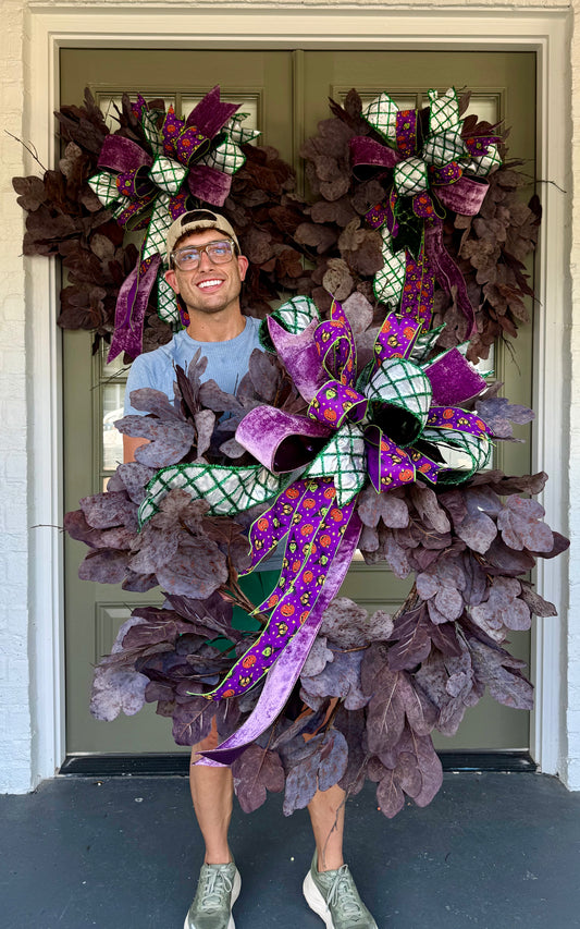 Faux Purple Leaf wreath , with hand tied JME Halloween bow. About 32 inches wide.