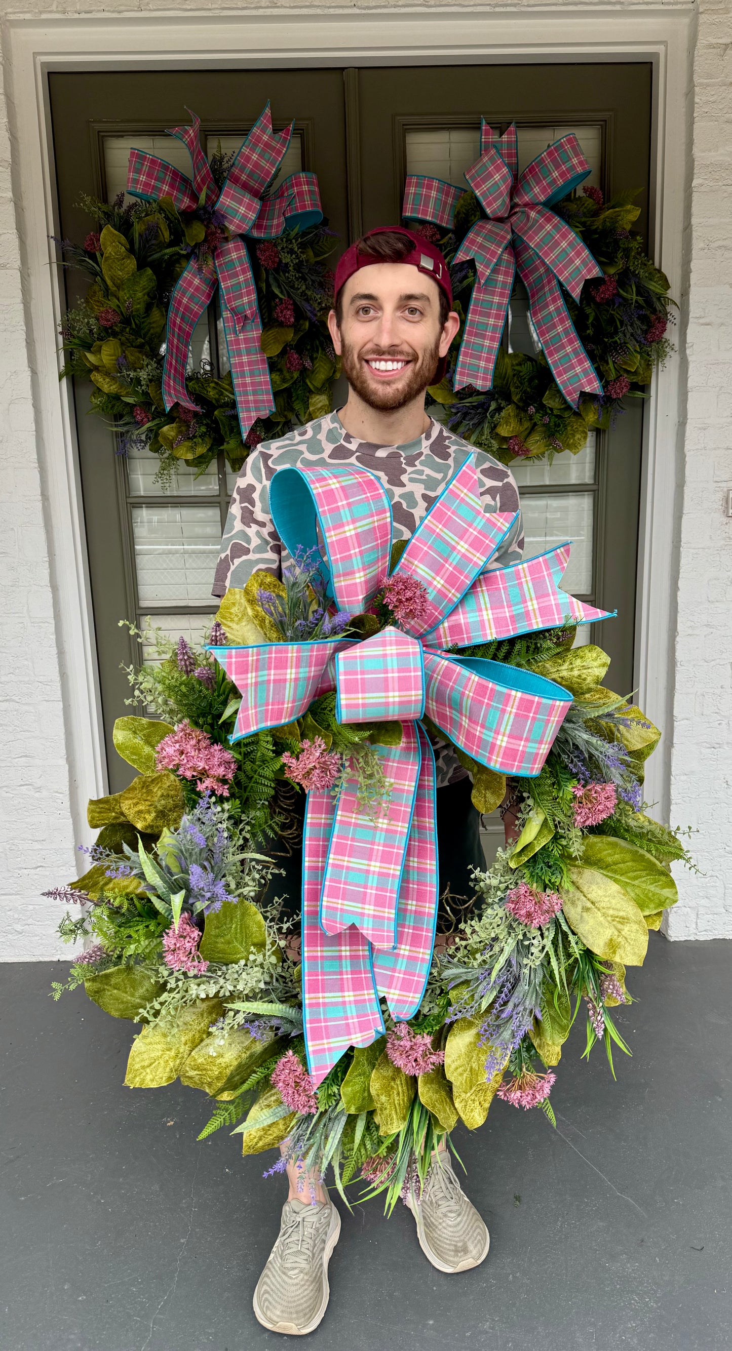 Pink and blue plaid bow wreath with spring flowers and magnolia leaves. Hand made by JME. 26inches wide