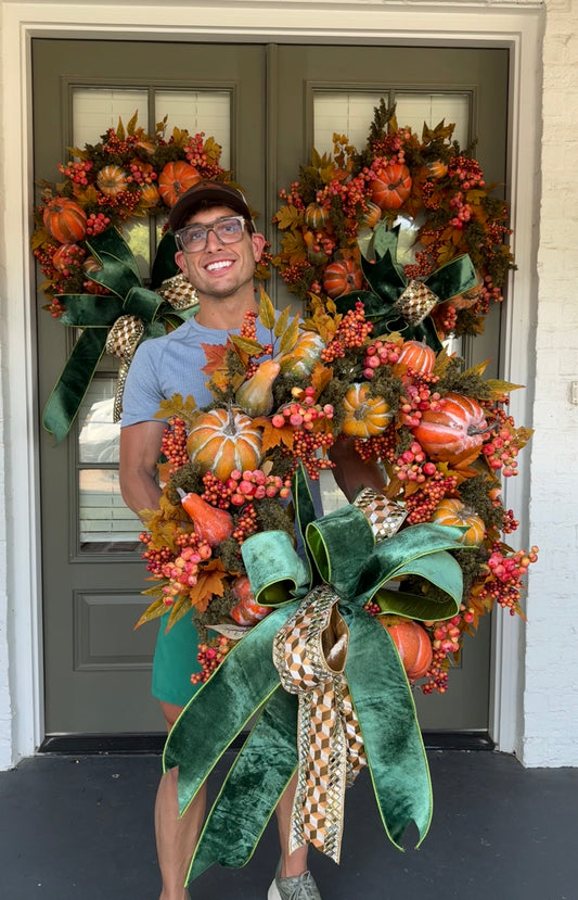 Faux moss and pumpkin JME wreath with A JME bow tied to it. About 30 inches.