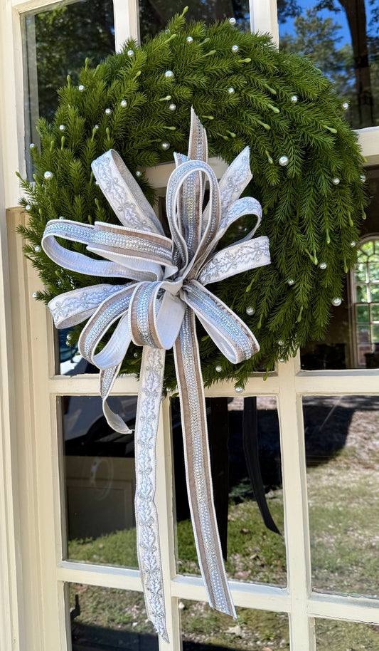 Pearl wreath with a JME hand tied bow. About 24 inches wide.
