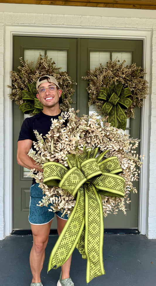 Faux cream eucalyptus and mixed foliage wreath with a hand tied green JME bow.