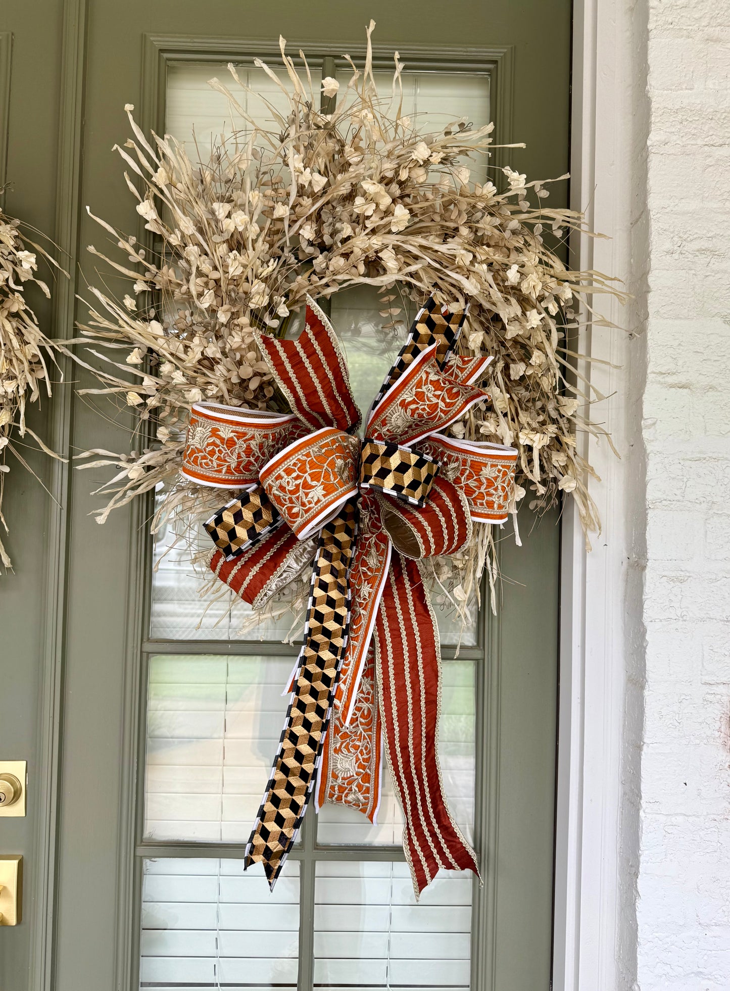 Faux cream paper flower wreath with JME hand tied bow. About 24 inches.