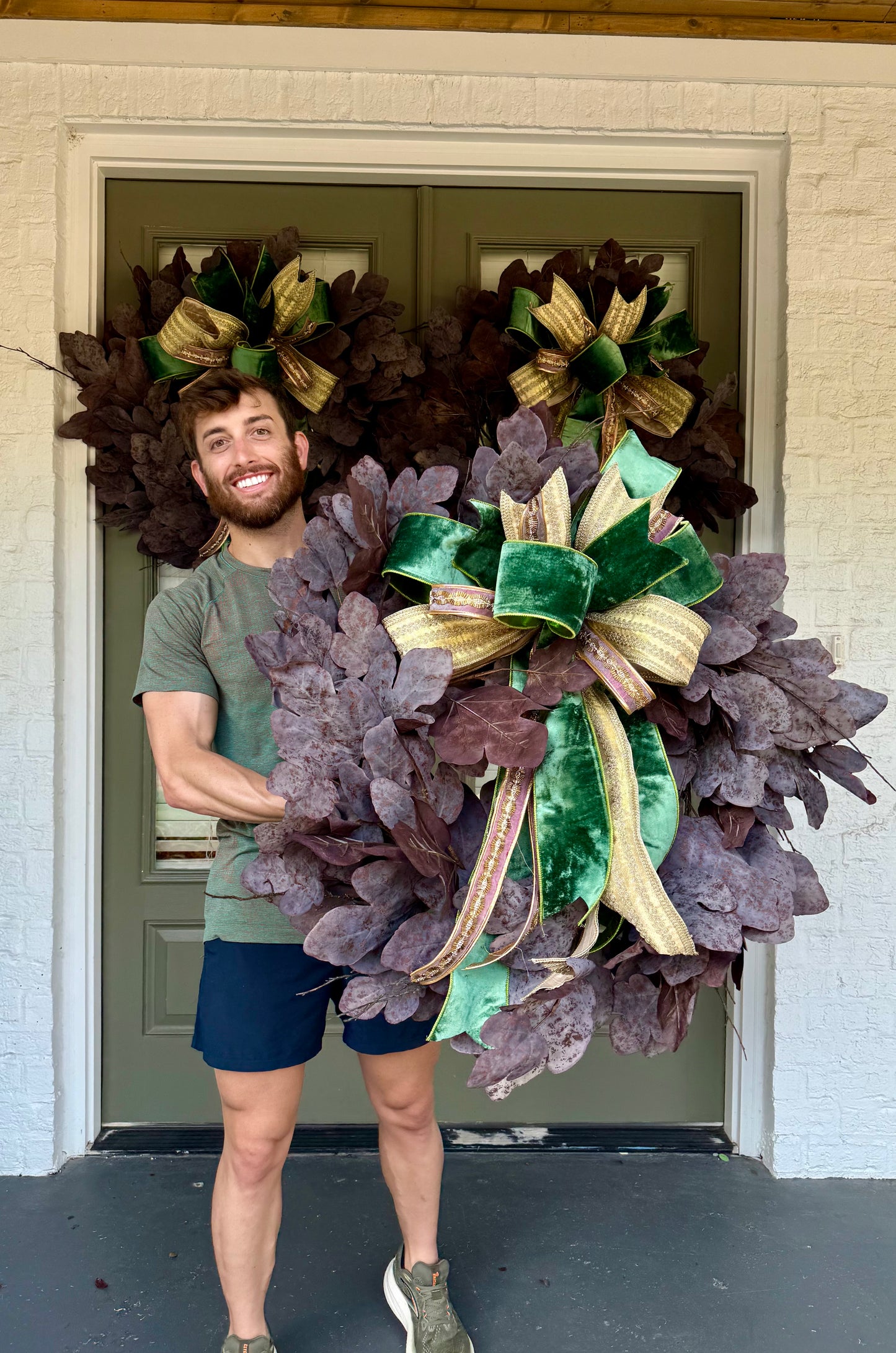 Faux plum colored fig leaf wreath with a JME hand tied bow. Green velvet, golds, and maroons with sparkle. About 32inches
