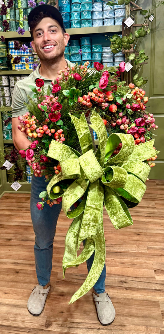 JME MADE faux wreath with crab apples, florals, and pine. Tied with a JME velvet GREEN bow. About 24 inches wide.