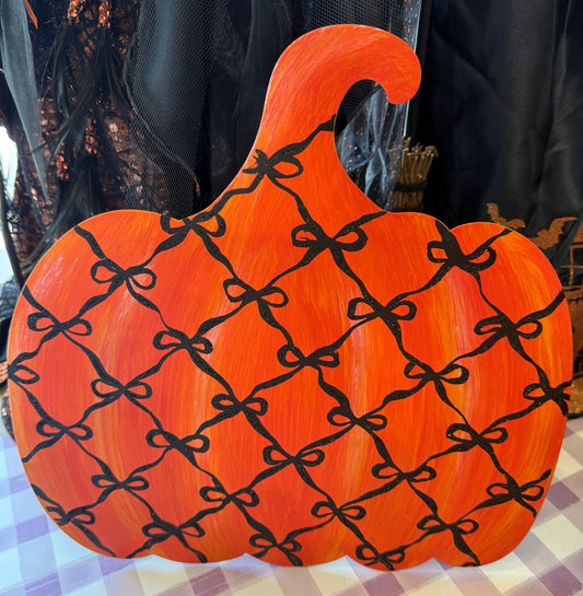 Metal bow pattern, pumpkin orange. Comes with a stake has an easel on the back and a hook that you can display easily with. 