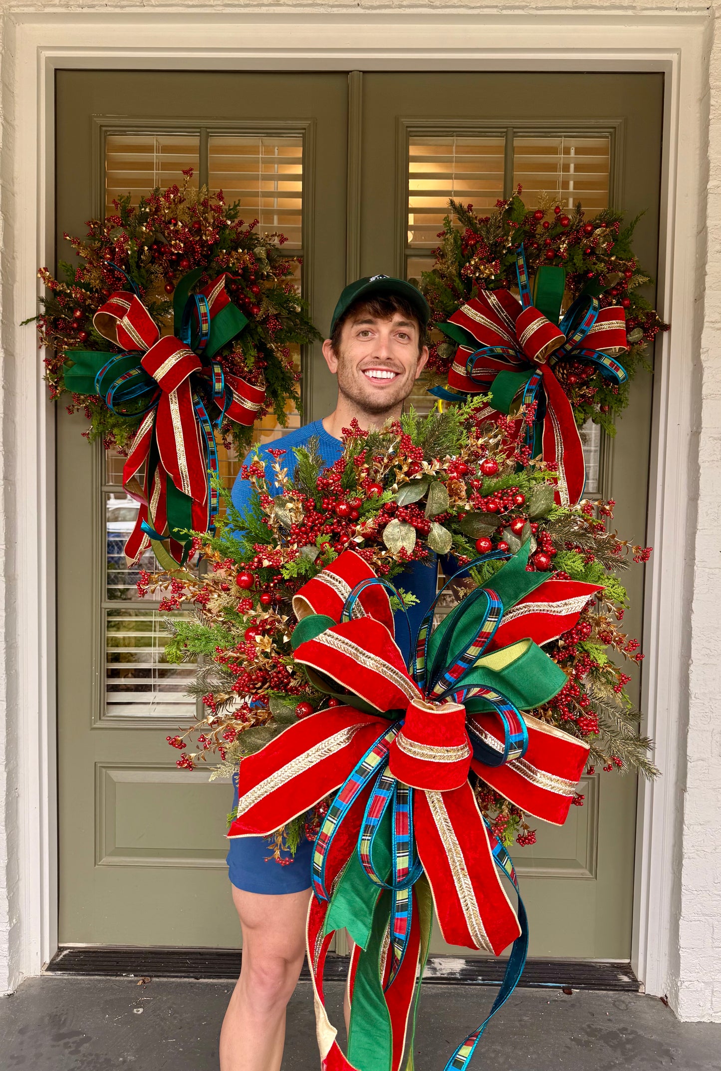 Red jingle bell JME handmade wreath with a JM nutcracker inspired bow. About 24 inches wide.