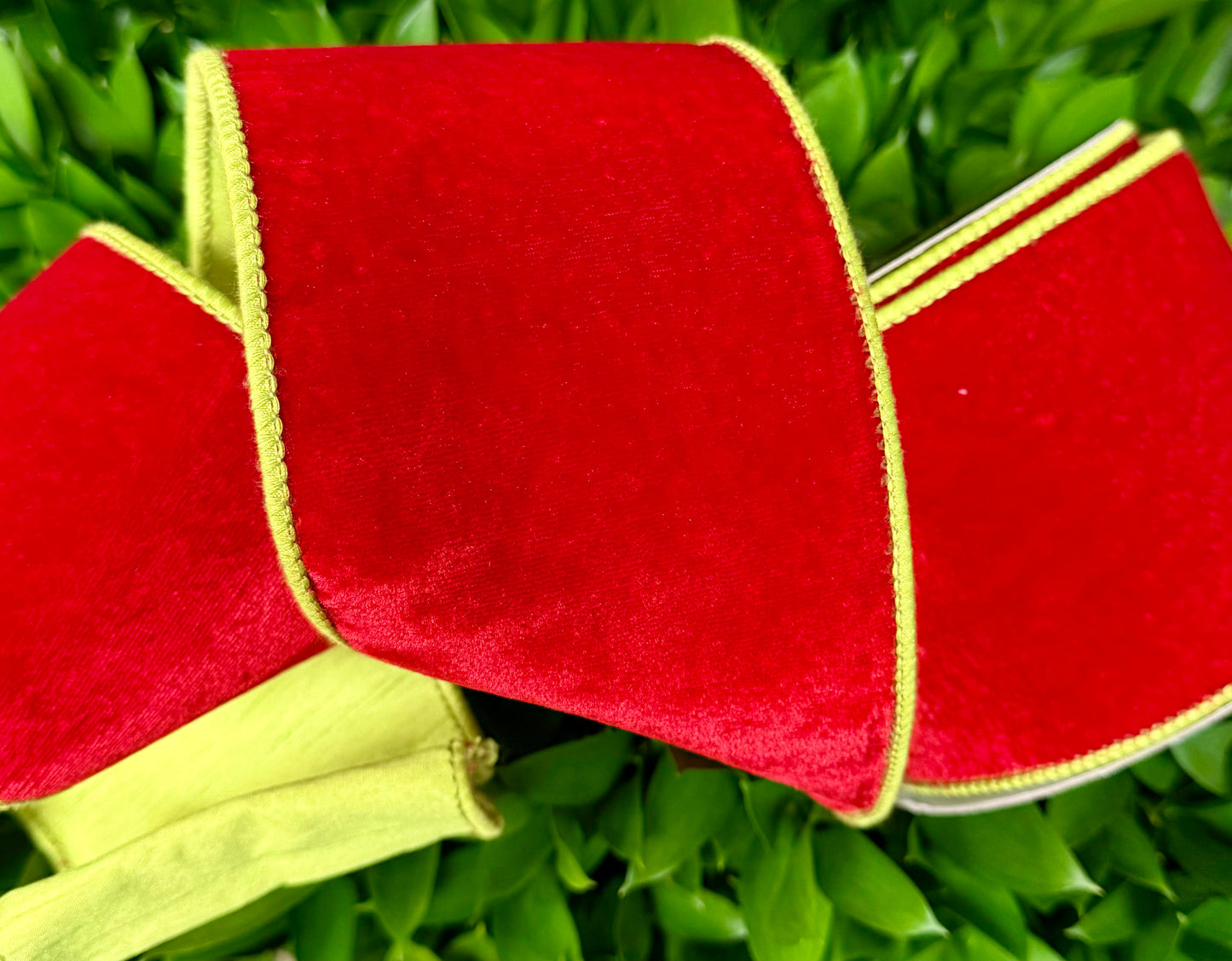 JME heavy wired ribbon. Red velvet with lime green backing and stitching. 4“ x 10 yards.