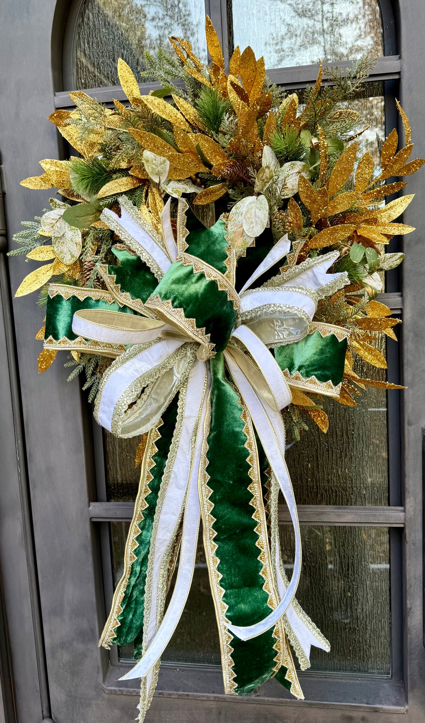 Greens and gold wreath. Handmade wreath by JME paired WITH A JME Handtied bow of velvets and jewels. About 24 inches wide
