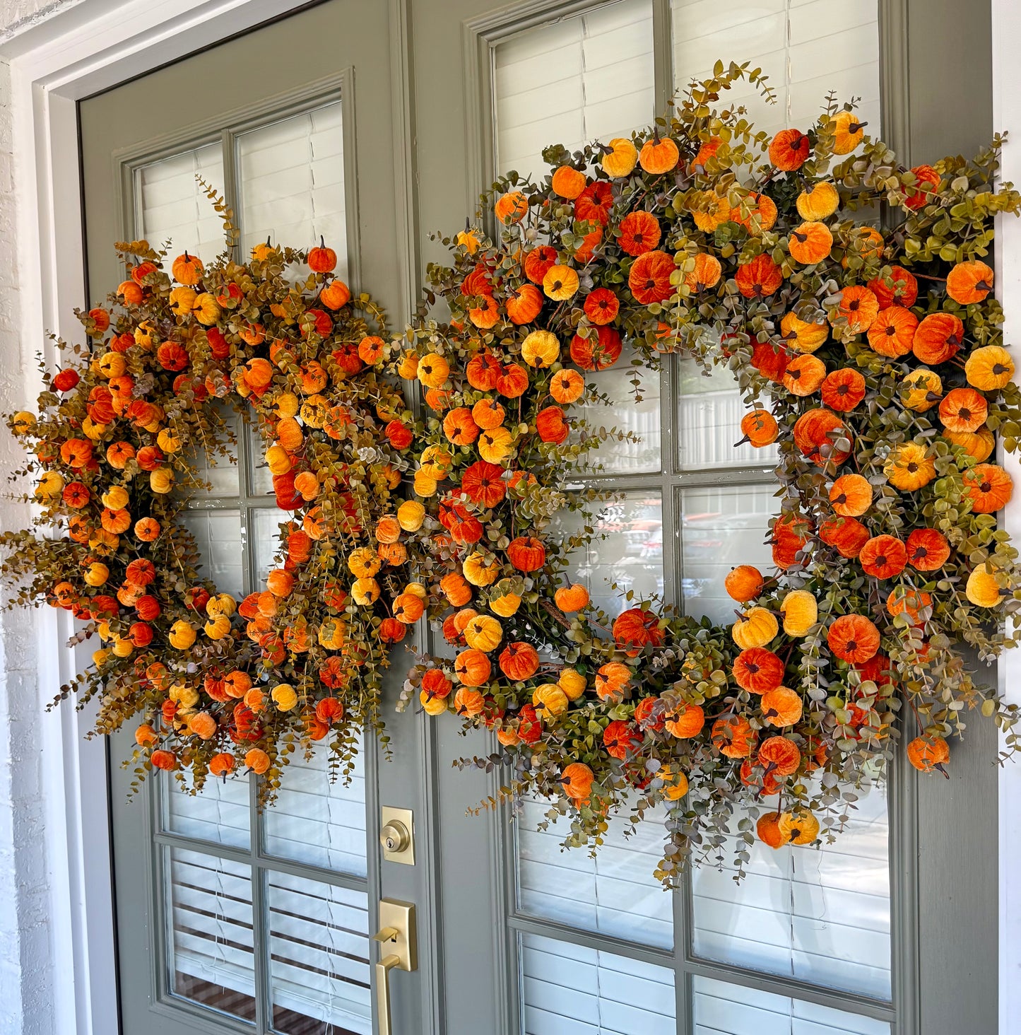 Faux orange velvet pumpkin wreath. 32 inches wide.