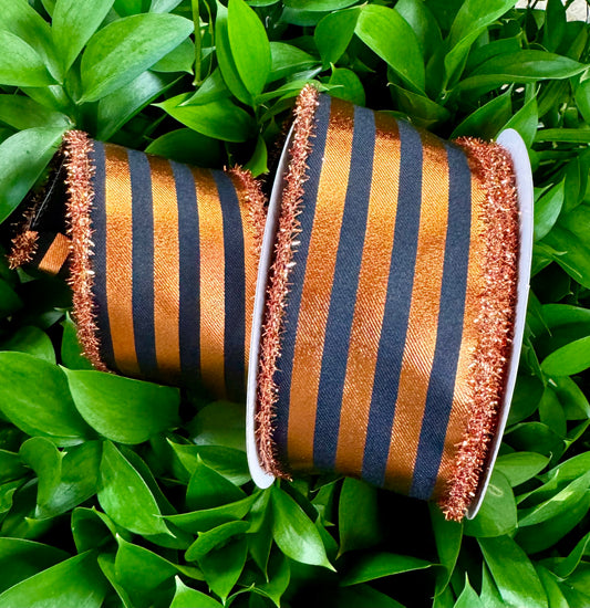 Black/orange vertical striped metallic wired ribbon. Orange tensel fringe with black backing. 2.5in by 10yards.