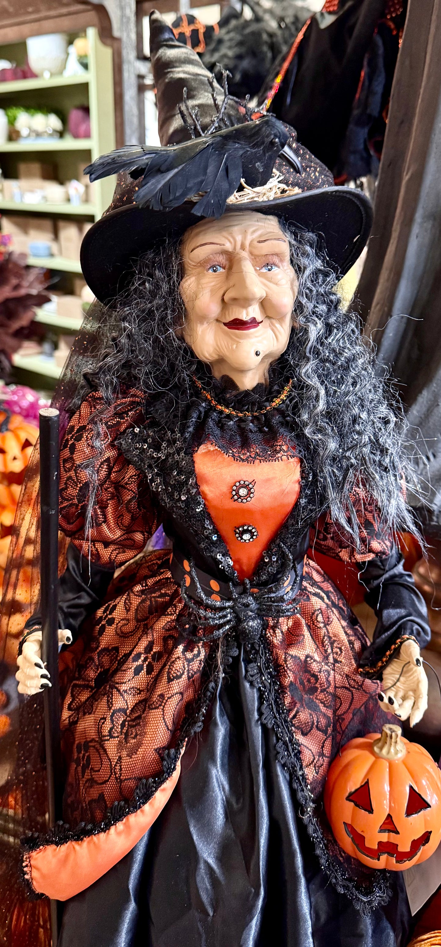 Tall witch figurine, holding a light up jack-o’-lantern. 42 inches tall. Has a Crow on her hat!