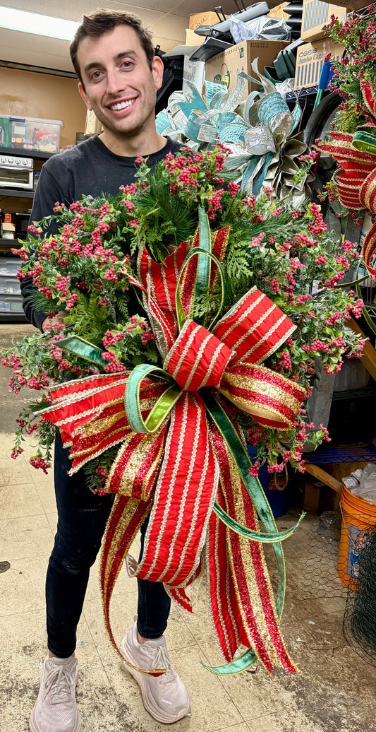 Traditional red berry wreath with red, green and gold bow. Approximately 24 inches wide. handmade by JME.