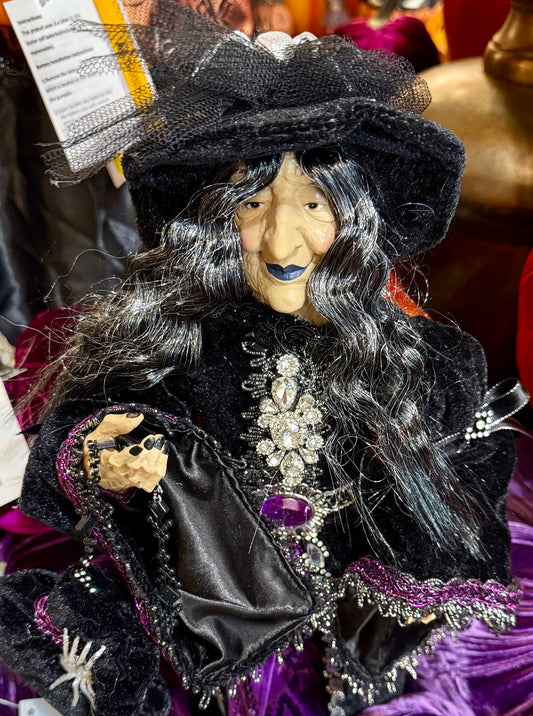 Purple passion witch figurine. With a purple and black cape and a spider on her hat. 24 inches tall.