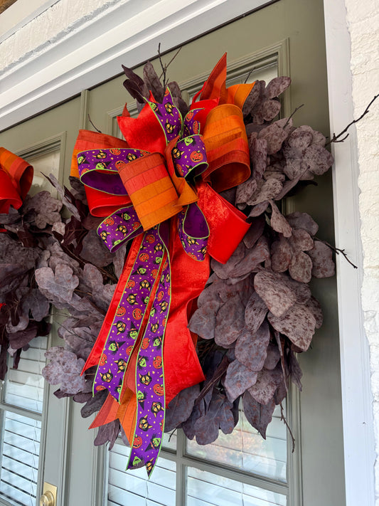 Faux plum colored fig leaf wreath with a JME hand tied bow. Halloween Bow. About 32inches