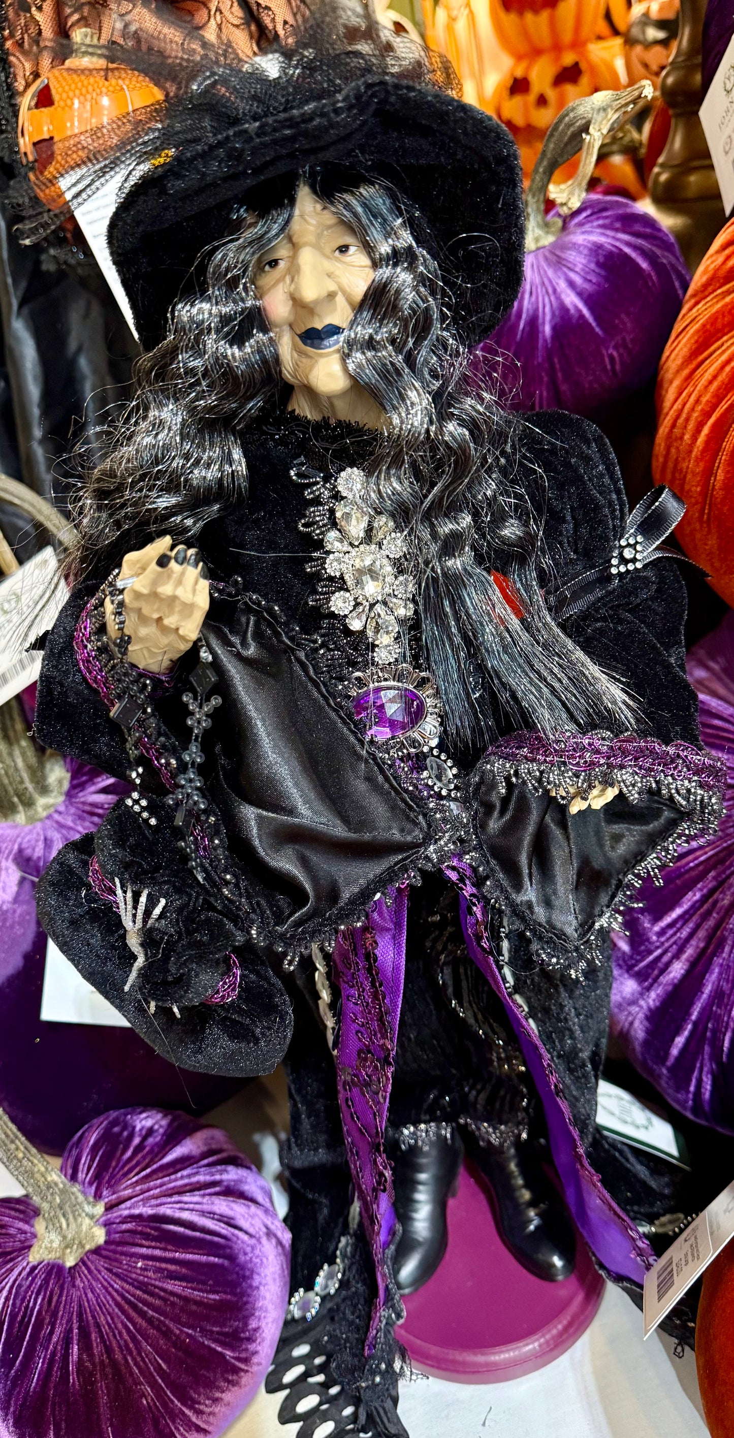 Purple passion witch figurine. With a purple and black cape and a spider on her hat. 24 inches tall.