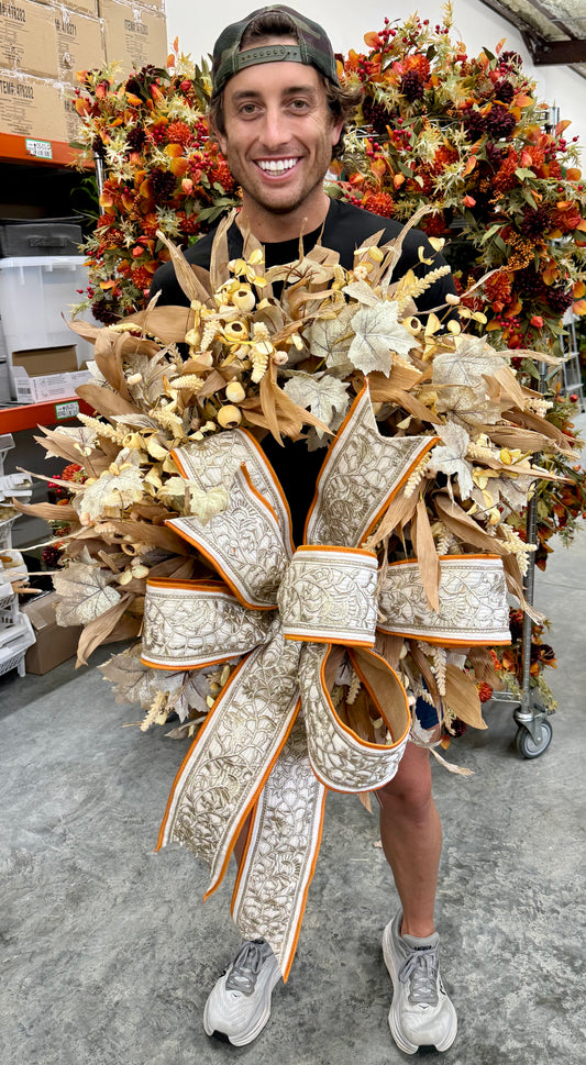Faux Fall corn husk and mixed leaf wreath with JME hand tied bow. 24 inches wide.