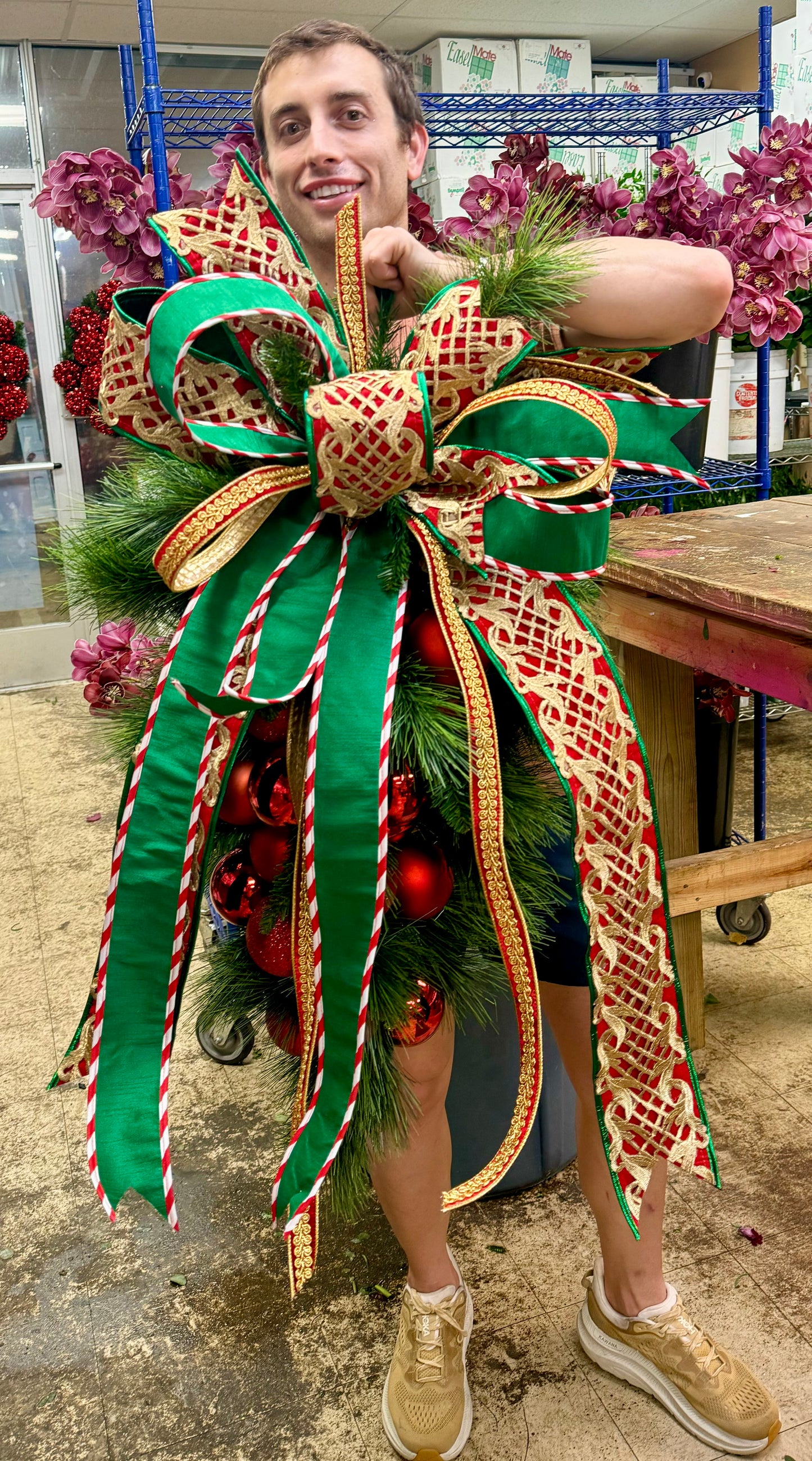 Traditional RED ball cluster door swag with a hand tied JME bow. Approximately 24 inches wide by 45 inches long.