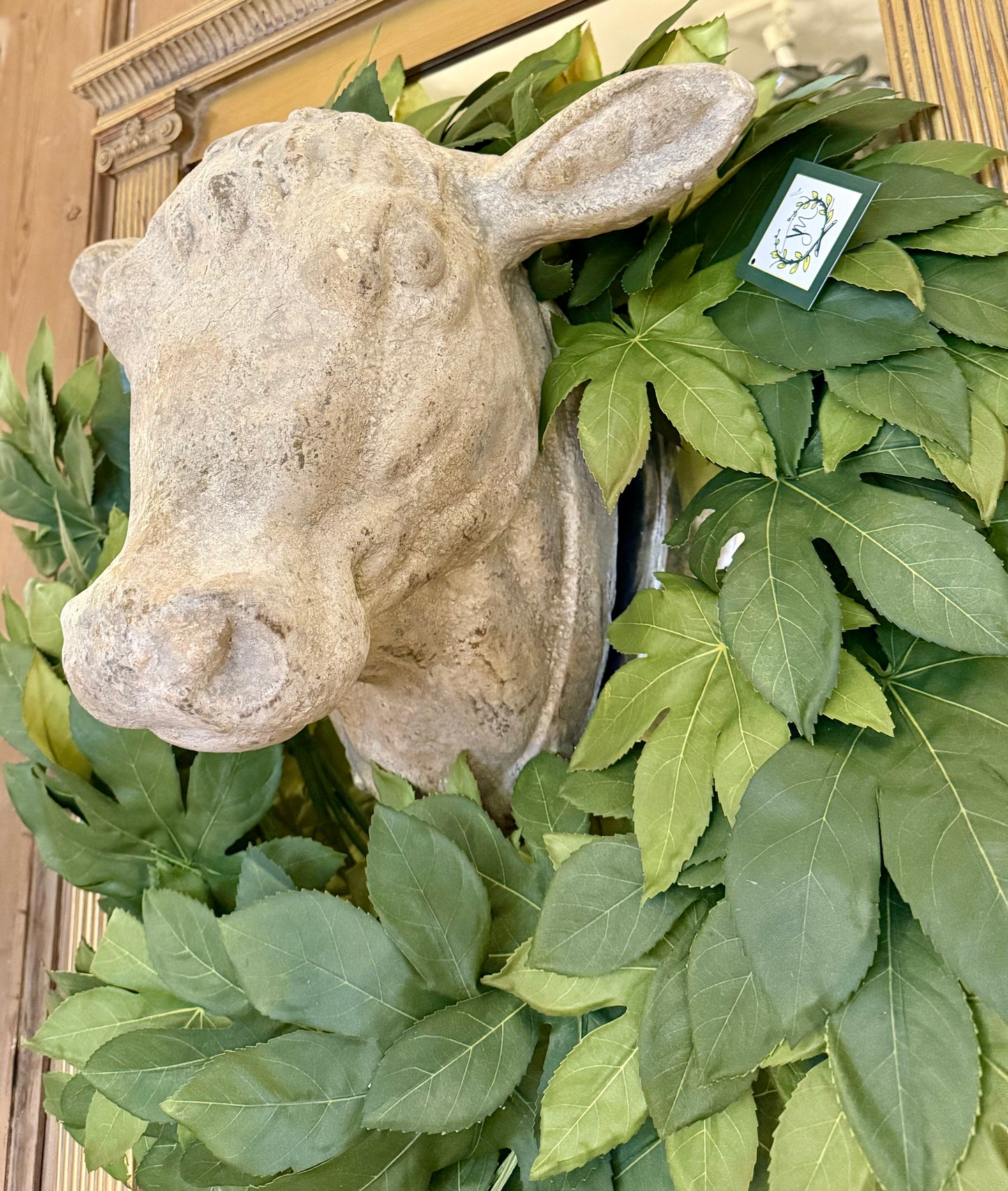 Weathered Stone Cow head. Able to be mounted on the wall. Greenery sold separately.