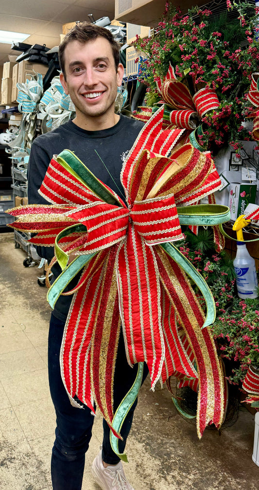 Hand tied JME bow, red, green and gold. Some fluffing may be required upon arrival.