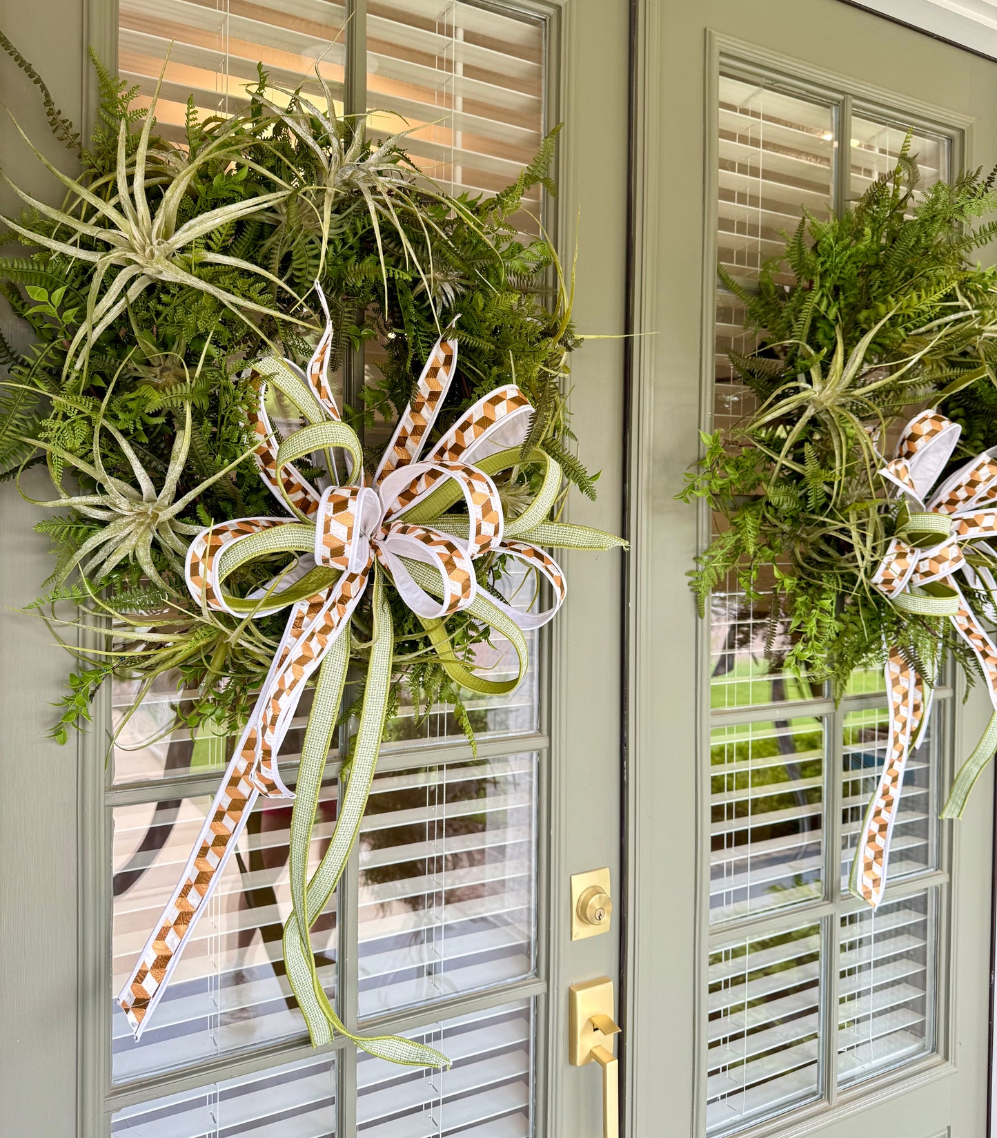 JME faux Succulent and fern wreath. With a JME ribbon bow! Around 24 inches wide.