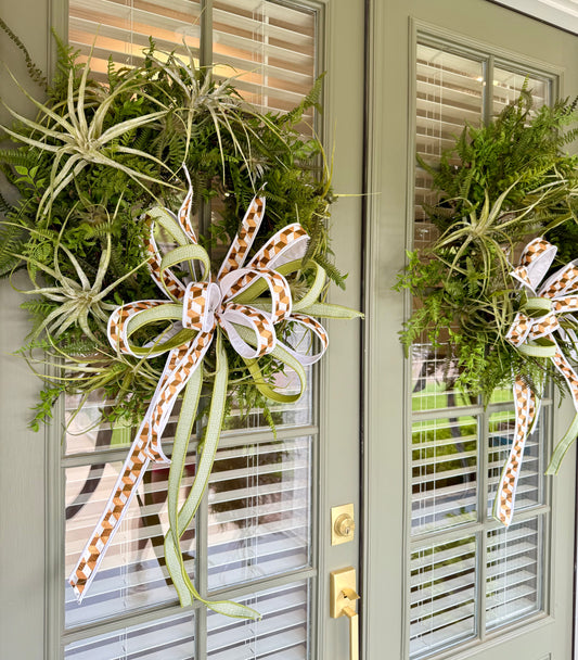 JME faux Succulent and fern wreath. With a JME ribbon bow! Around 24 inches wide.