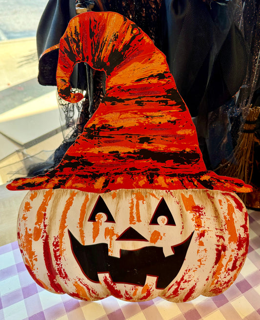 Metal jack-o’-lantern with witch hat stake. White. 18 inches. Has an easel that can be propped up on the back and it has a hook that could be hung on the door or wall.