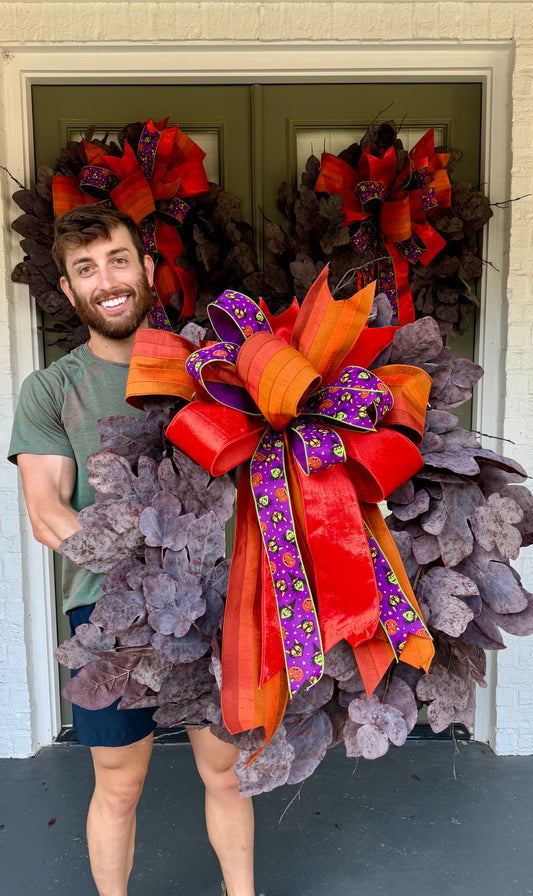 Faux plum colored fig leaf wreath with a JME hand tied bow. Halloween Bow. About 32inches