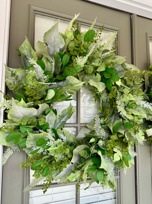 28in all faux foliage wreath. Made with different textures and shades of greenery.