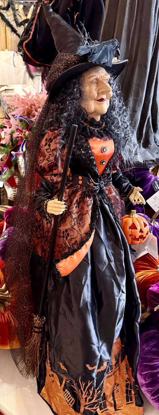 Tall witch figurine, holding a light up jack-o’-lantern. 42 inches tall. Has a Crow on her hat!
