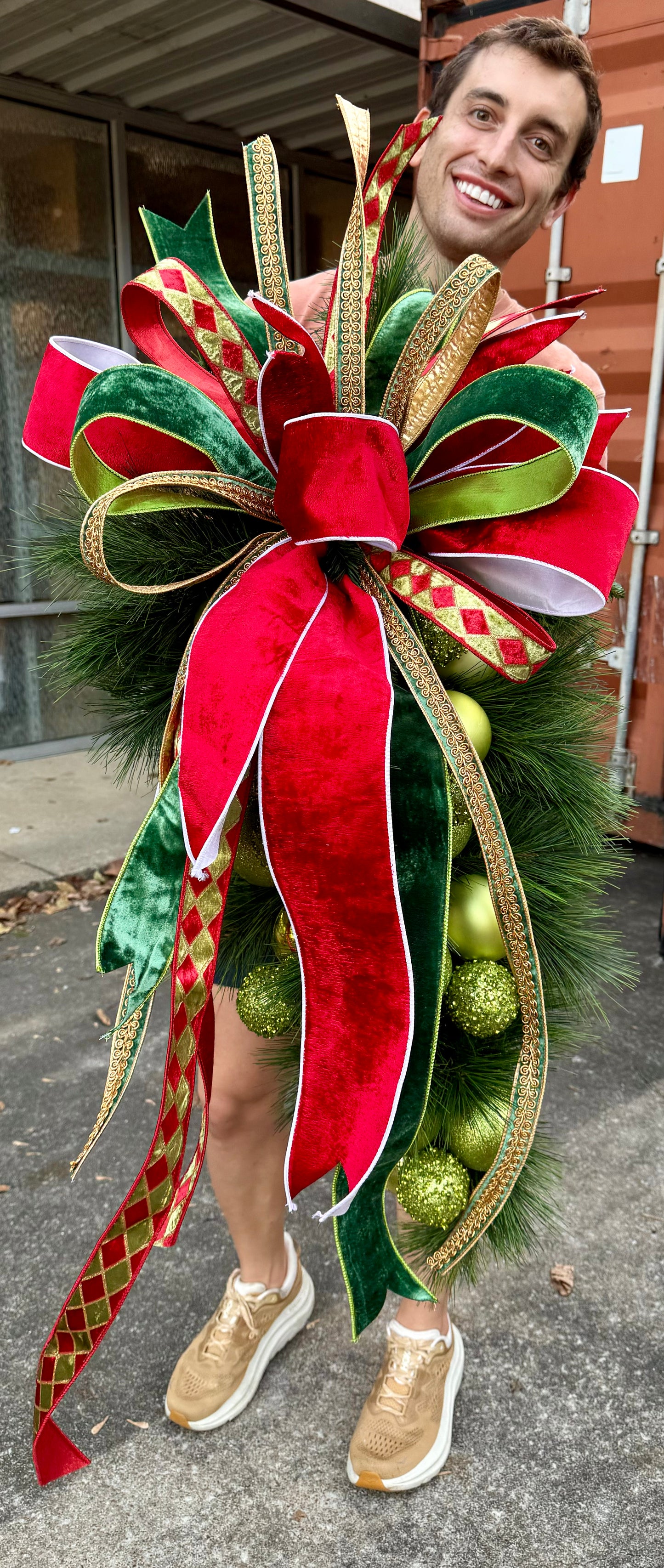 Traditional GREEN ball cluster door swag with a hand tied JME bow. Approximately 24 inches wide by 45 inches long.