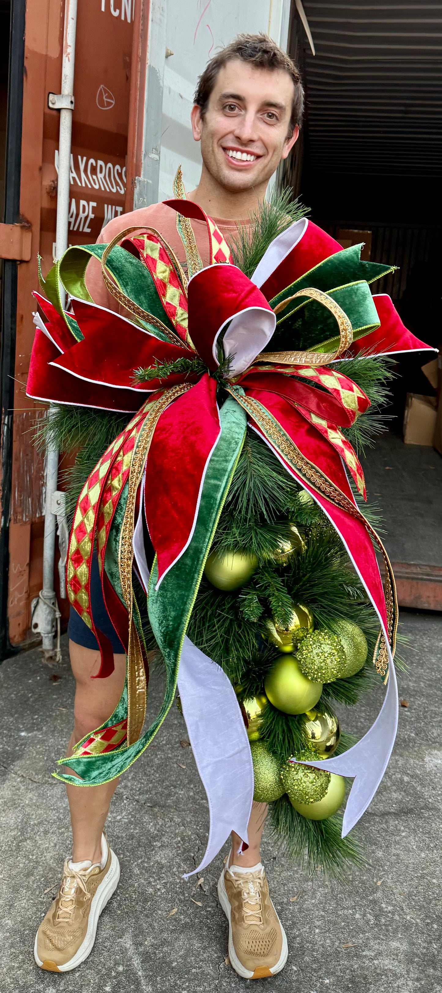 Traditional GREEN ball cluster door swag with a hand tied JME bow. Approximately 24 inches wide by 45 inches long.