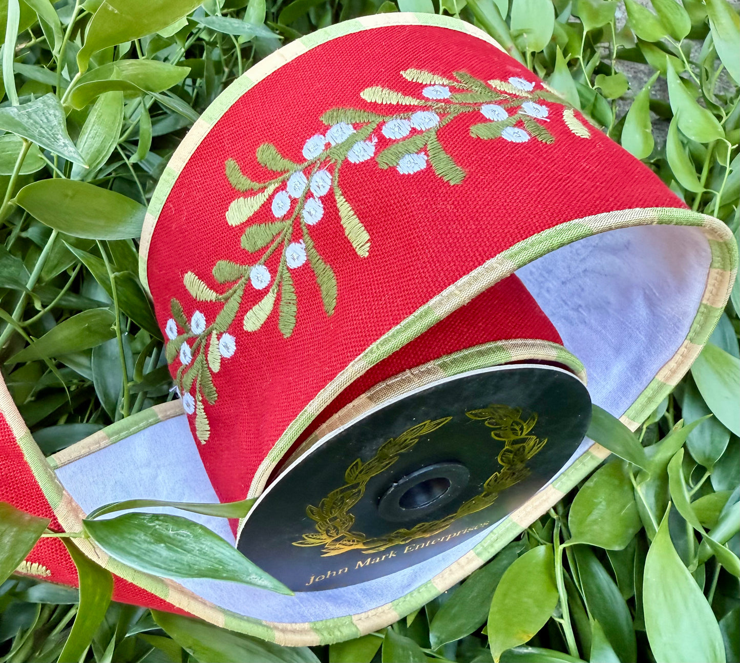 JM a heavy wired ribbon. Embroidered mistletoe on red dupion. backed with white and piped with green and tan check. 4” x 5 yards