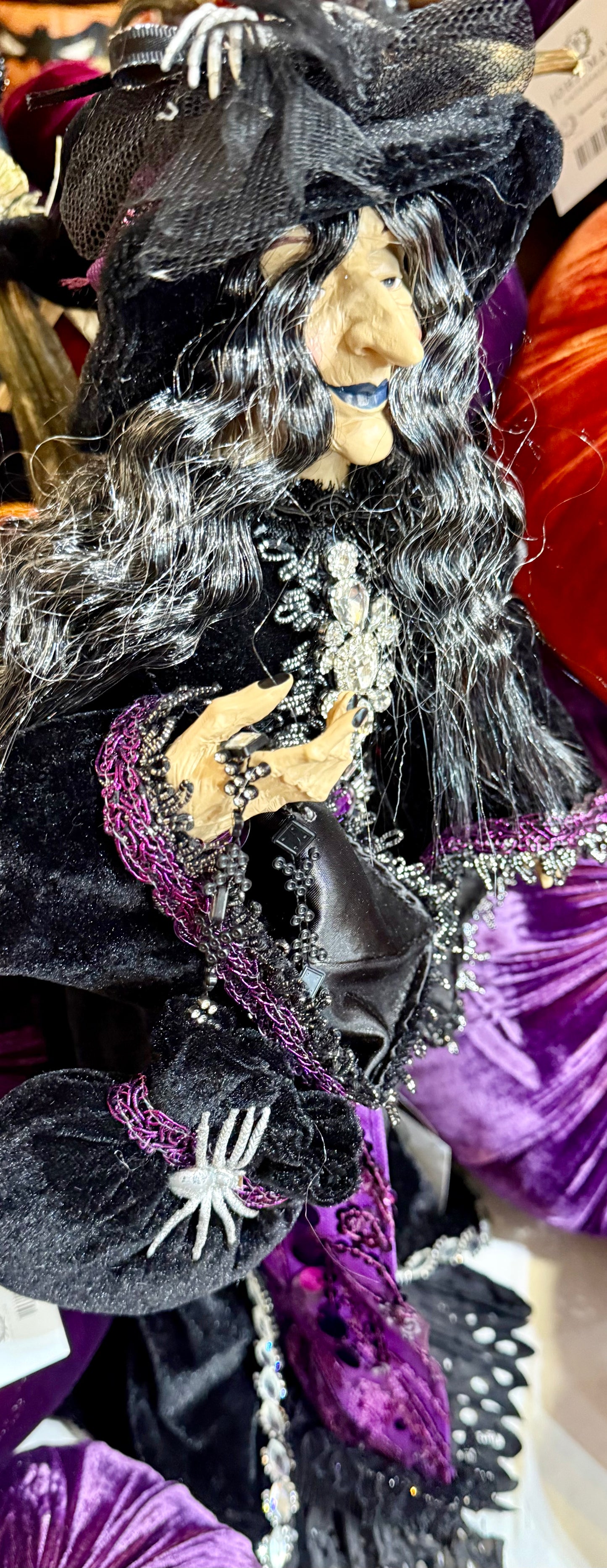 Purple passion witch figurine. With a purple and black cape and a spider on her hat. 24 inches tall.