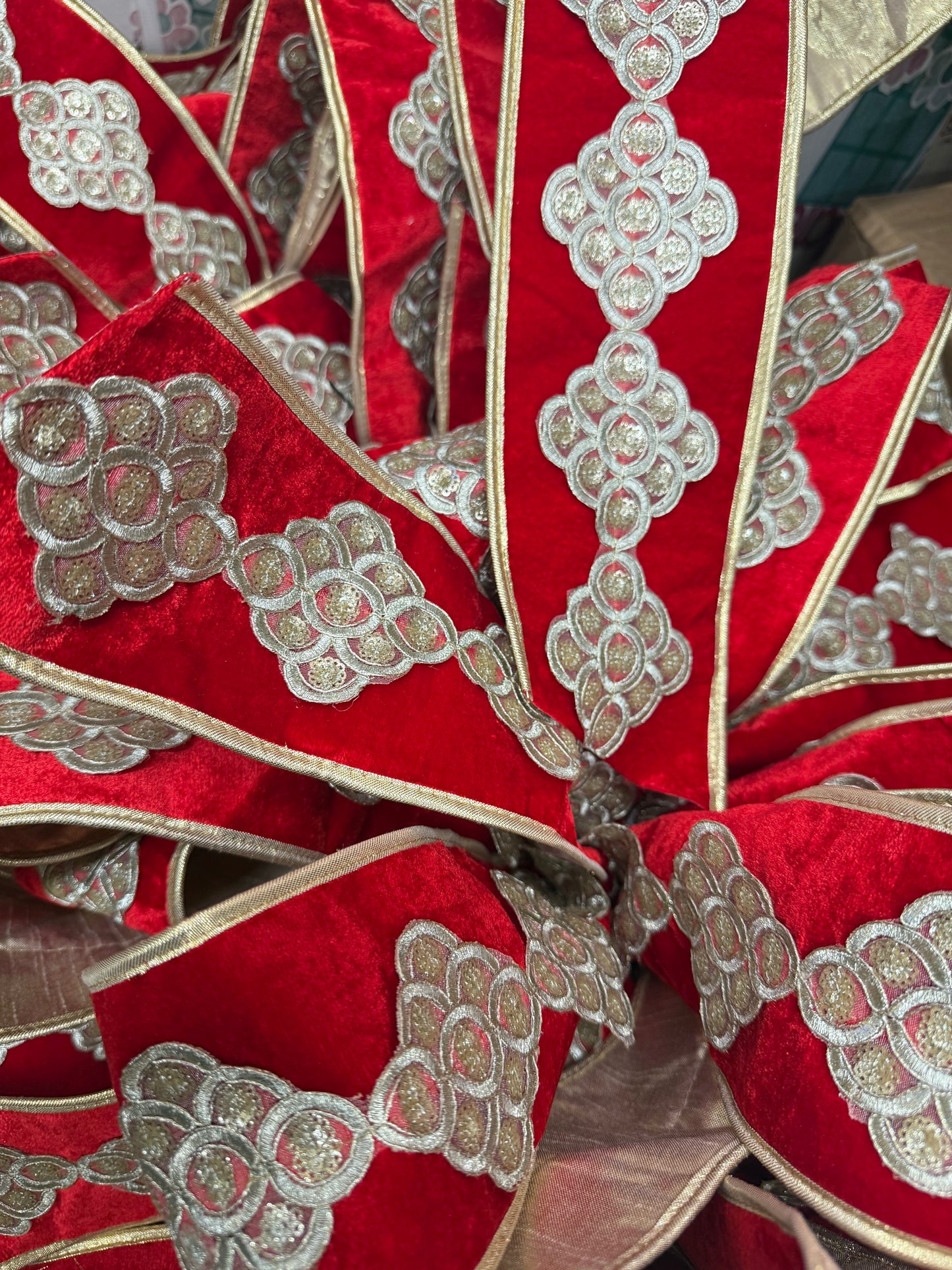 Lux JME red velvet bow with gold piping and beautiful trim work. Hand tied by JME. 10 yards of ribbon. Ribbon is 4inches wide. The bow measures approximately 2 feed wide by 3 feet long